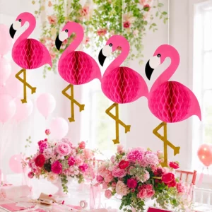 Four pink flamingo honeycomb decorations hanging above a floral party table