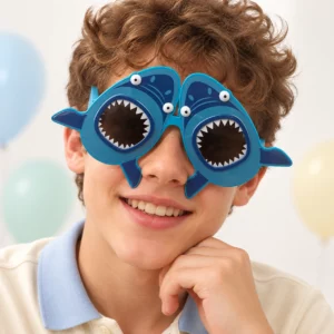 Boy wearing blue shark party glasses with white teeth around the lenses