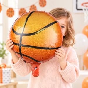 Girl holding Basketball Foil Balloon 18 inch against a pale background