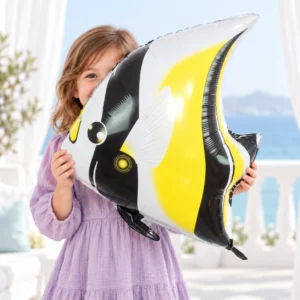 Girl holding a black, white and yellow Moorish Idol fish foil balloon