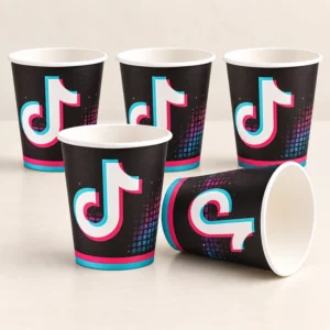 Five black neon music-note paper cups on a pale tabletop, with one cup on its side