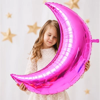 Girl holding Pink Giant Moon Foil Balloon 90cm against a pale background