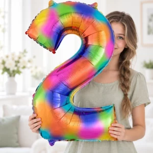 Girl holding Rainbow Foil Number 2 Balloon 100cm against a pale background