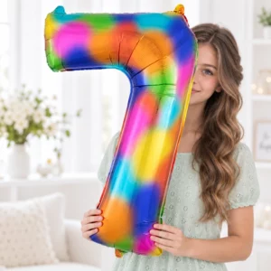 Girl holding Rainbow Foil Number 7 Balloon 100cm against a pale background