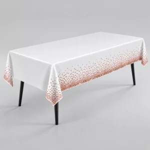 White tablecover with rose gold confetti dot borders draped over a rectangular table on a grey background